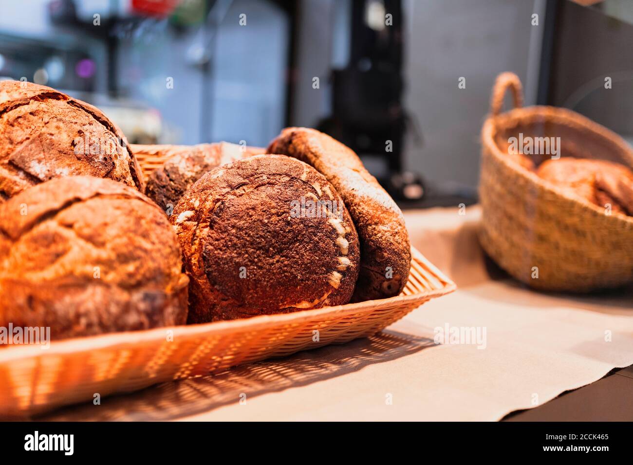 Close-up of baked bread in container over kitchen counter Stock Photo