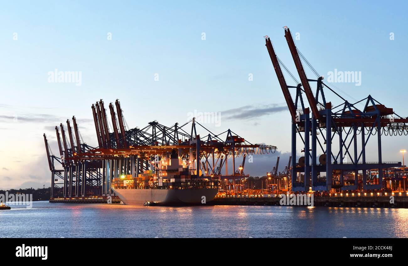 transport and logistics by water - loading of ships in a port with goods for export Stock Photo
