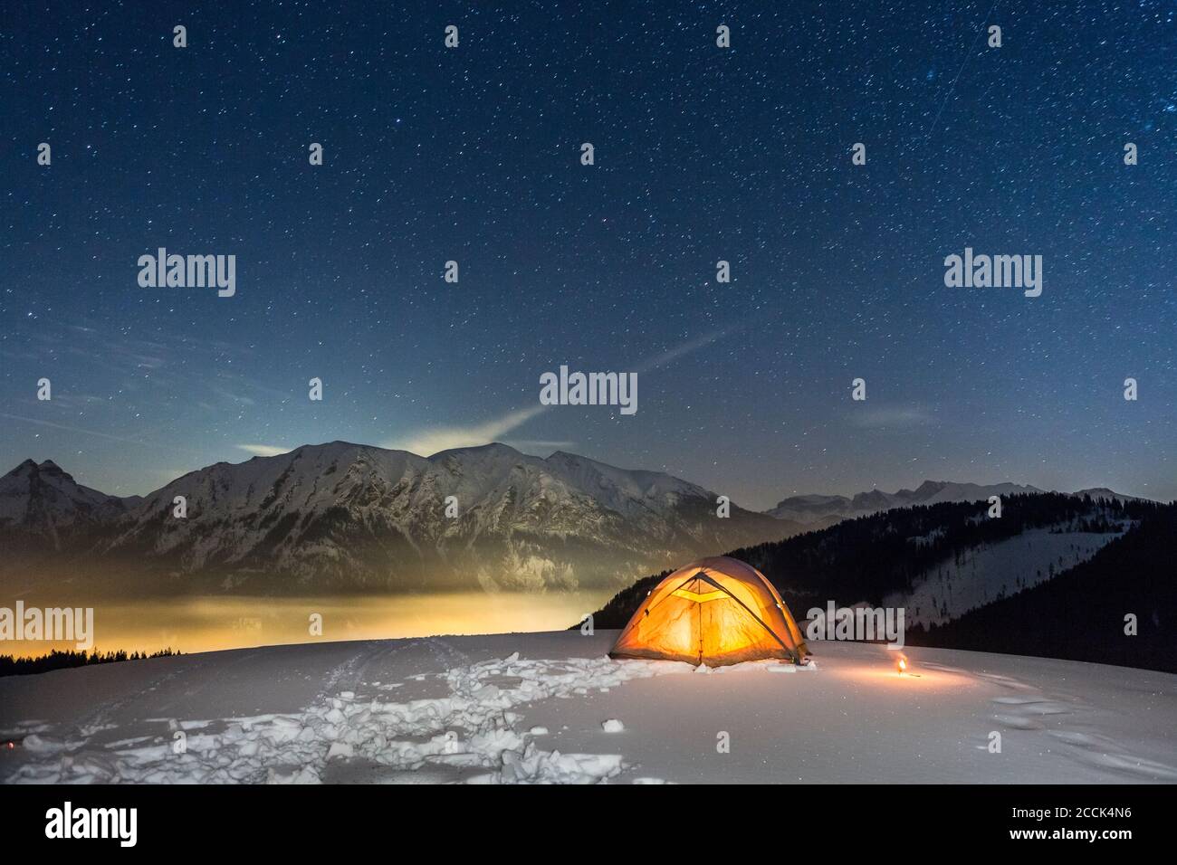 Nightscape of glowing tent in the snow, Achenkirch, Austria Stock Photo