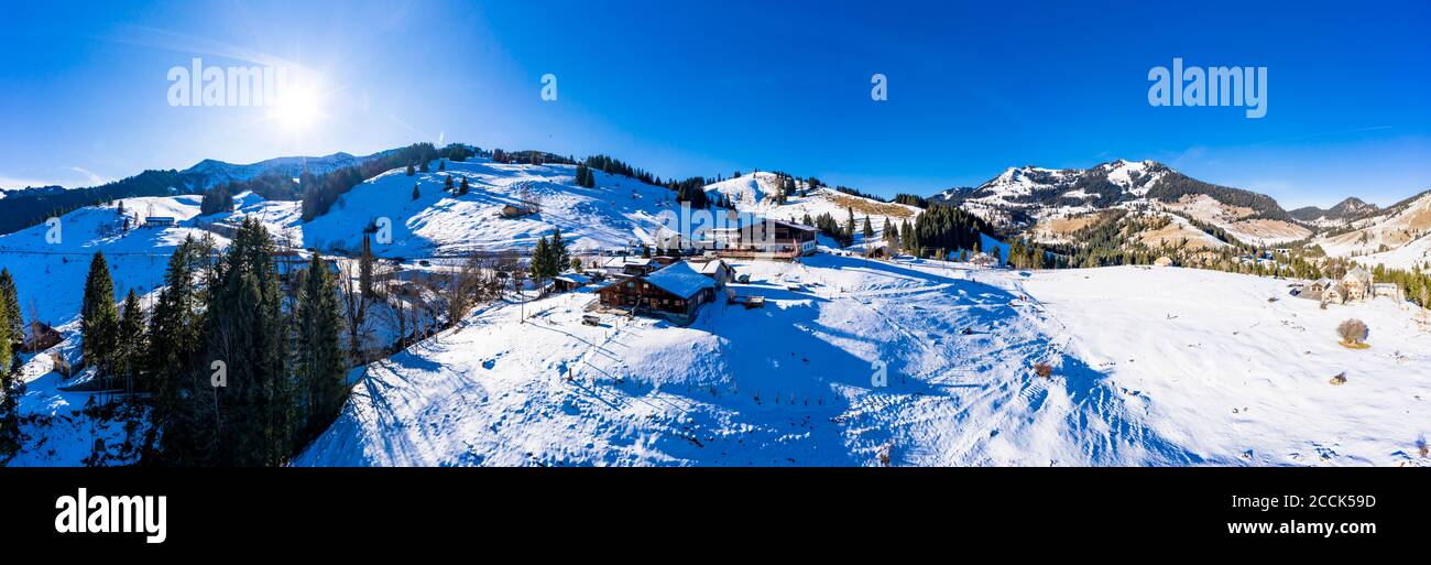 Helicopter panorama of sun shining over Sudelfeld ski resort Stock Photo