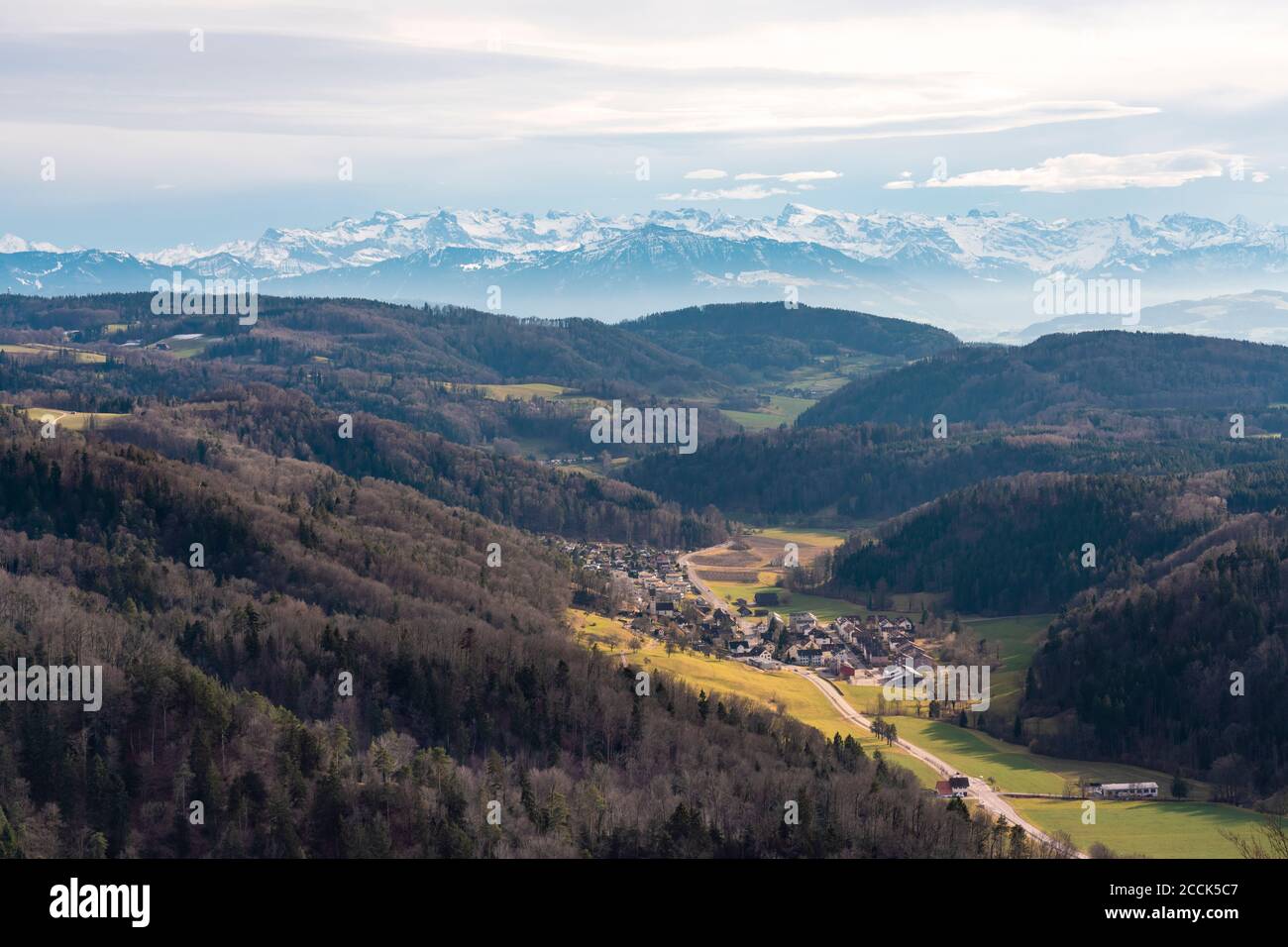 Switzerland, around Zurich, Village in valley with snow covered ...