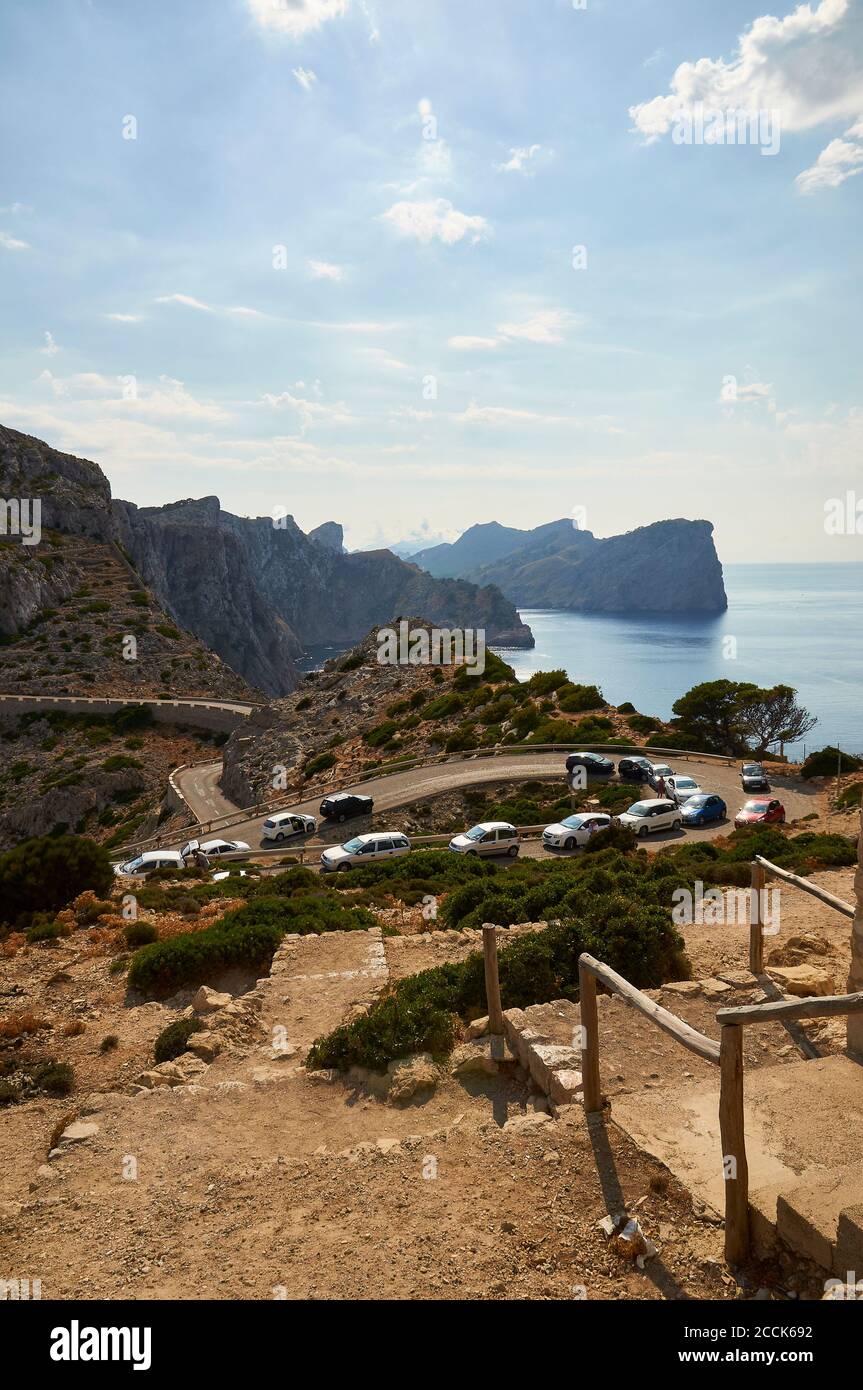 Traffic jam at the road to Formentor cape lighthouse, with coastline landscape in the background (Majorca, Balearic Islands, Mediterranean sea, Spain) Stock Photo