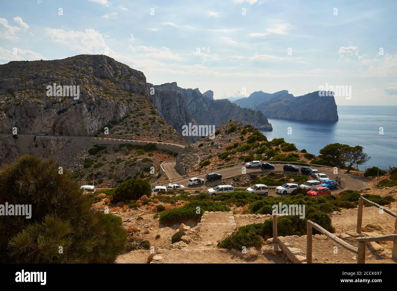 Traffic jam at the road to Formentor cape lighthouse, with coastline landscape in the background (Majorca, Balearic Islands, Mediterranean sea, Spain) Stock Photo