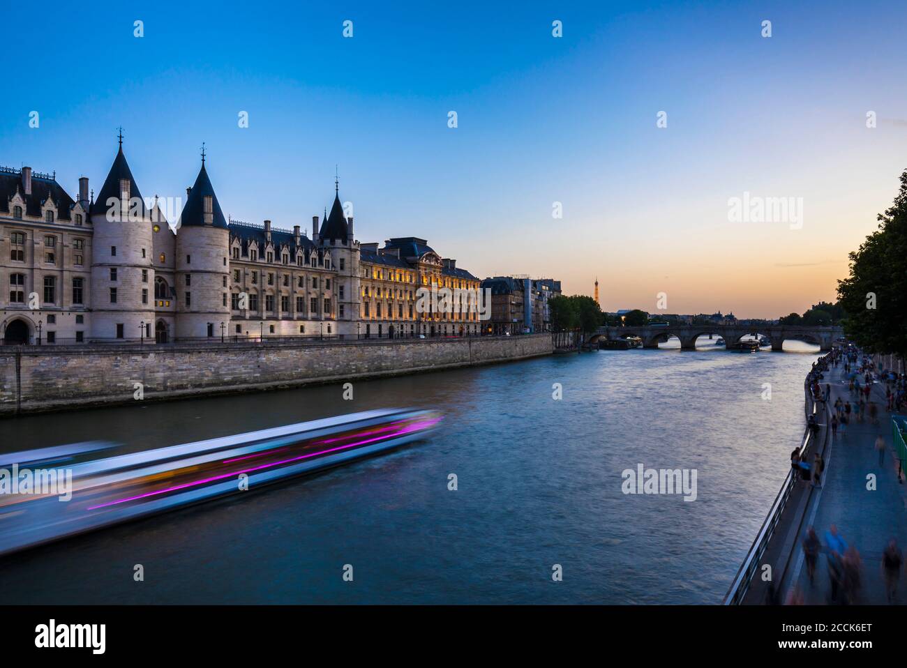 Cruise ship in Seine river against clear blue sky during sunrise, Paris, France Stock Photo