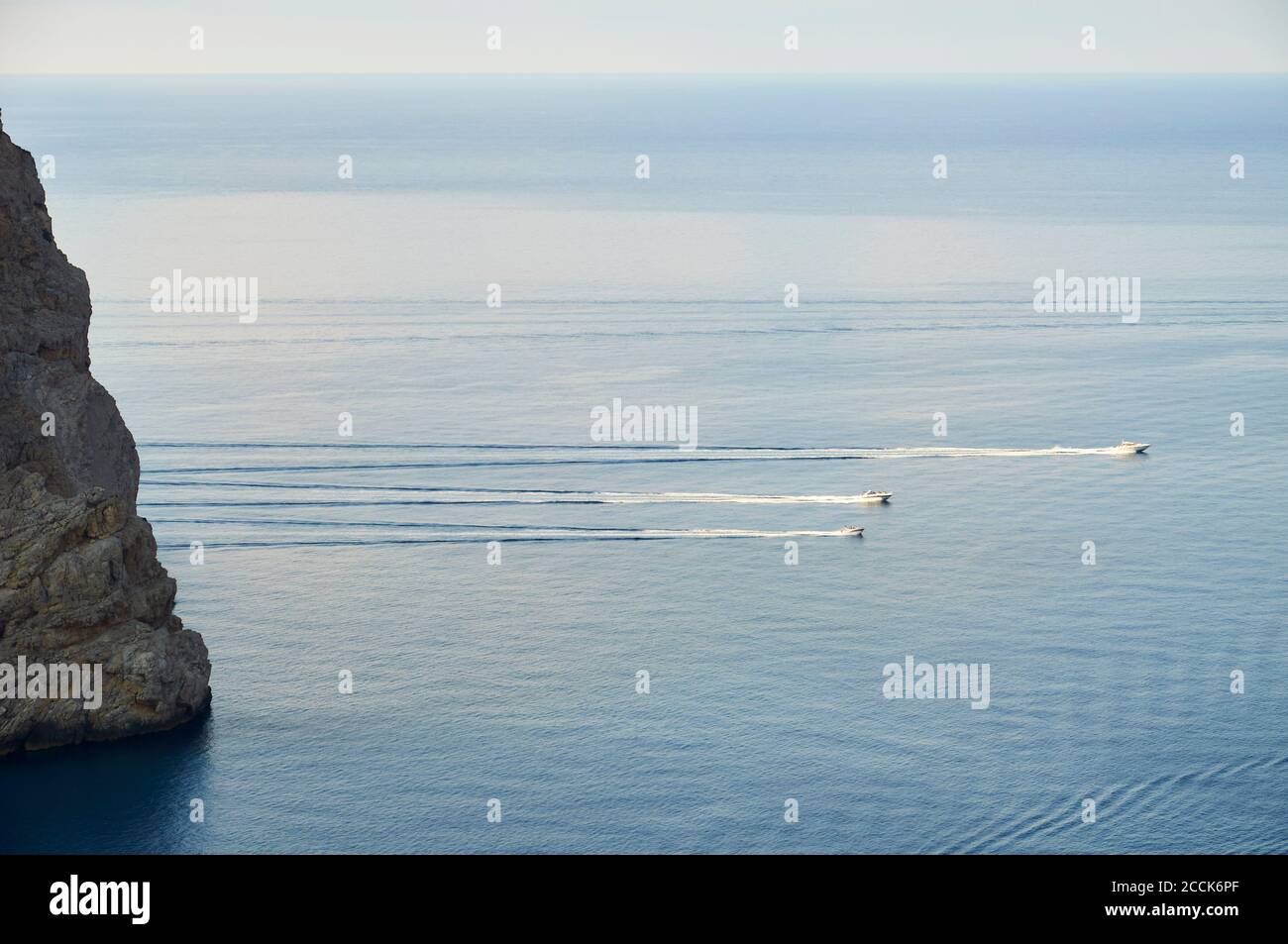 Recreational boats sailing next to Cap de Catalunya cape near Formentor cape (Formentor peninsula, Majorca, Balearic Islands, Mediterranean sea,Spain) Stock Photo