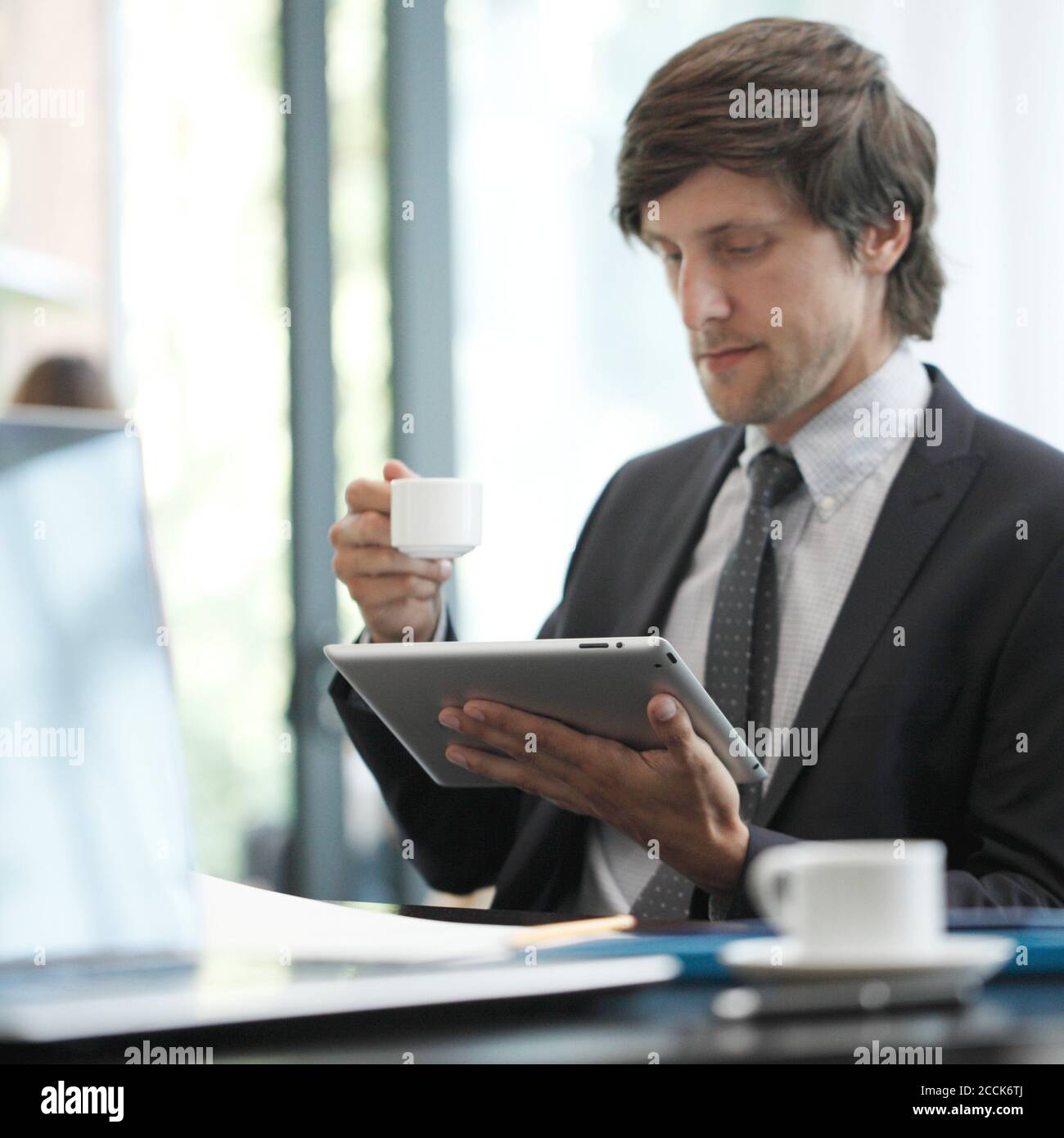 Business man with tablet computer in cafe Stock Photo