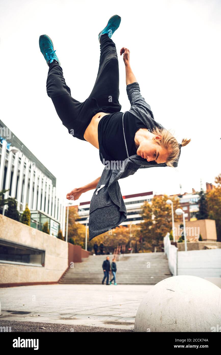 Young man jumping against clear sky Stock Photo