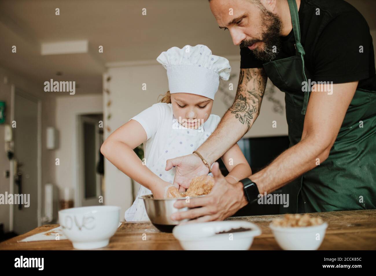 Father and daughter baking cookies at home Stock Photo