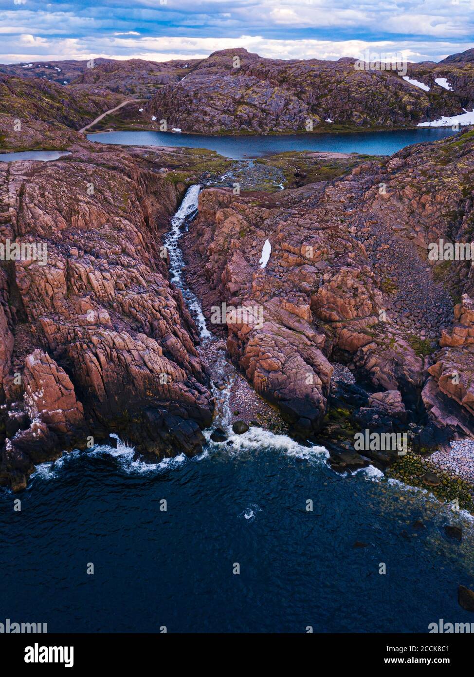 Russia, Murmansk Oblast, Teriberka, Aerial view of waterfall at coast