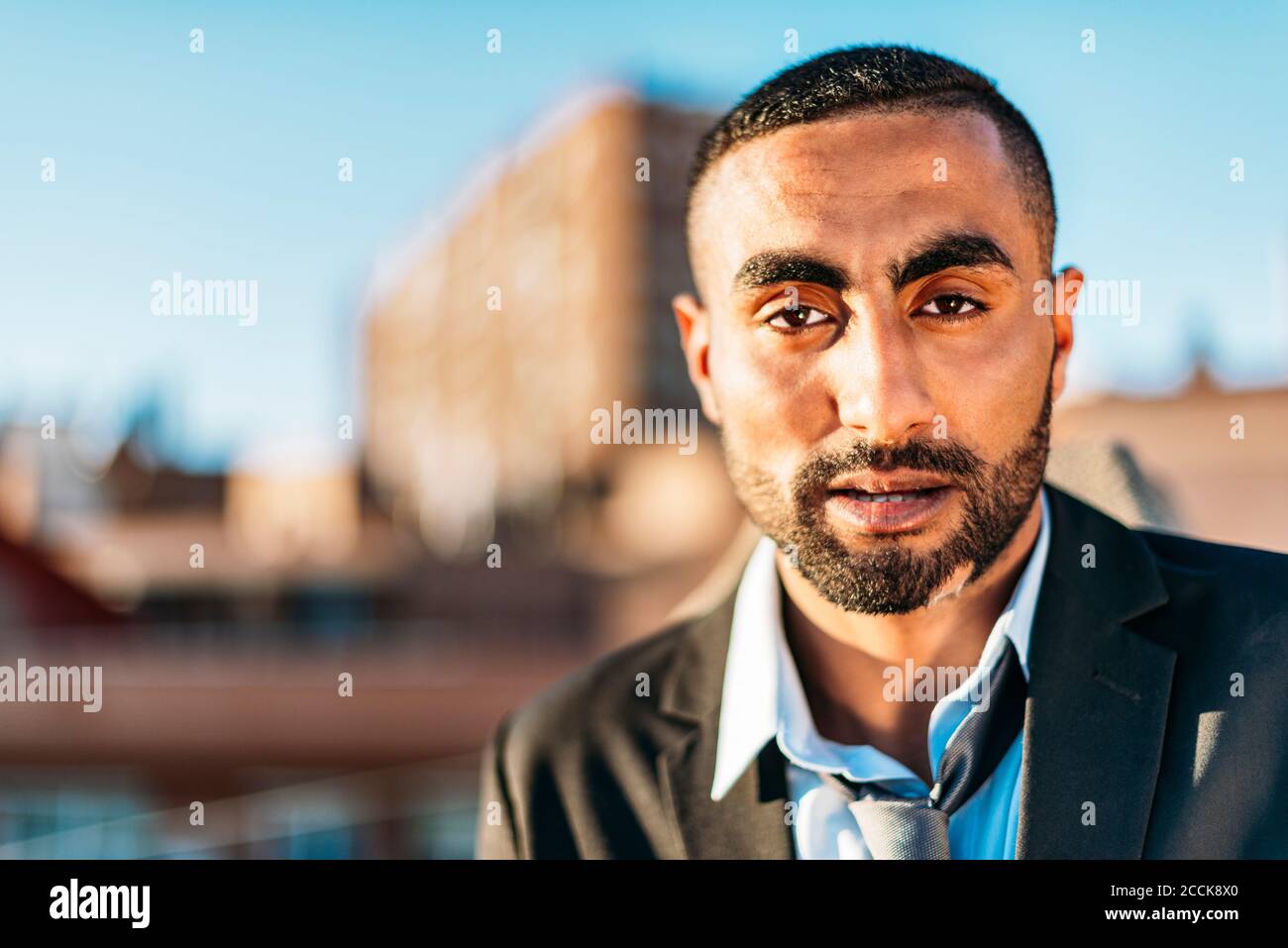 Young male professional in suit at rooftop Stock Photo