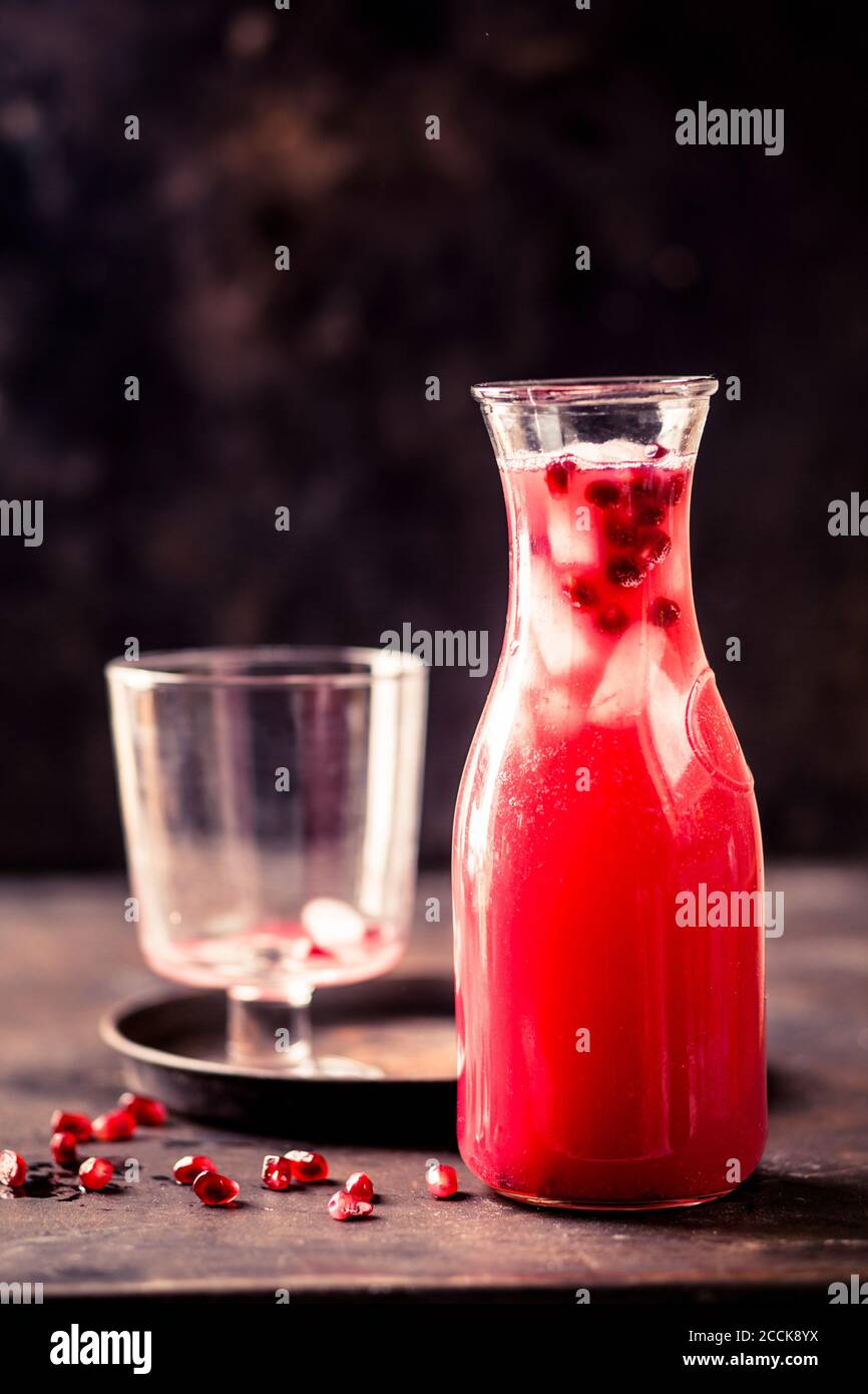 Carafe of pomegranate fizz with pomegranate juice, ice cubes and tonic water Stock Photo Alamy
