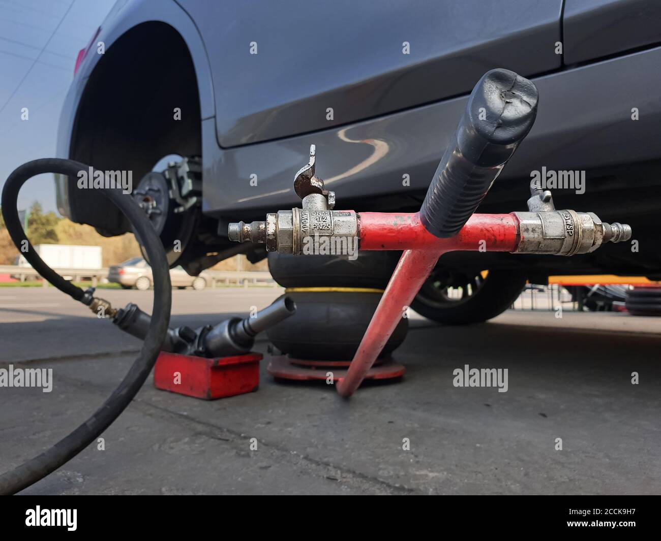 Tire. Seasonal change of car tires. Car without a wheel on a jack Stock