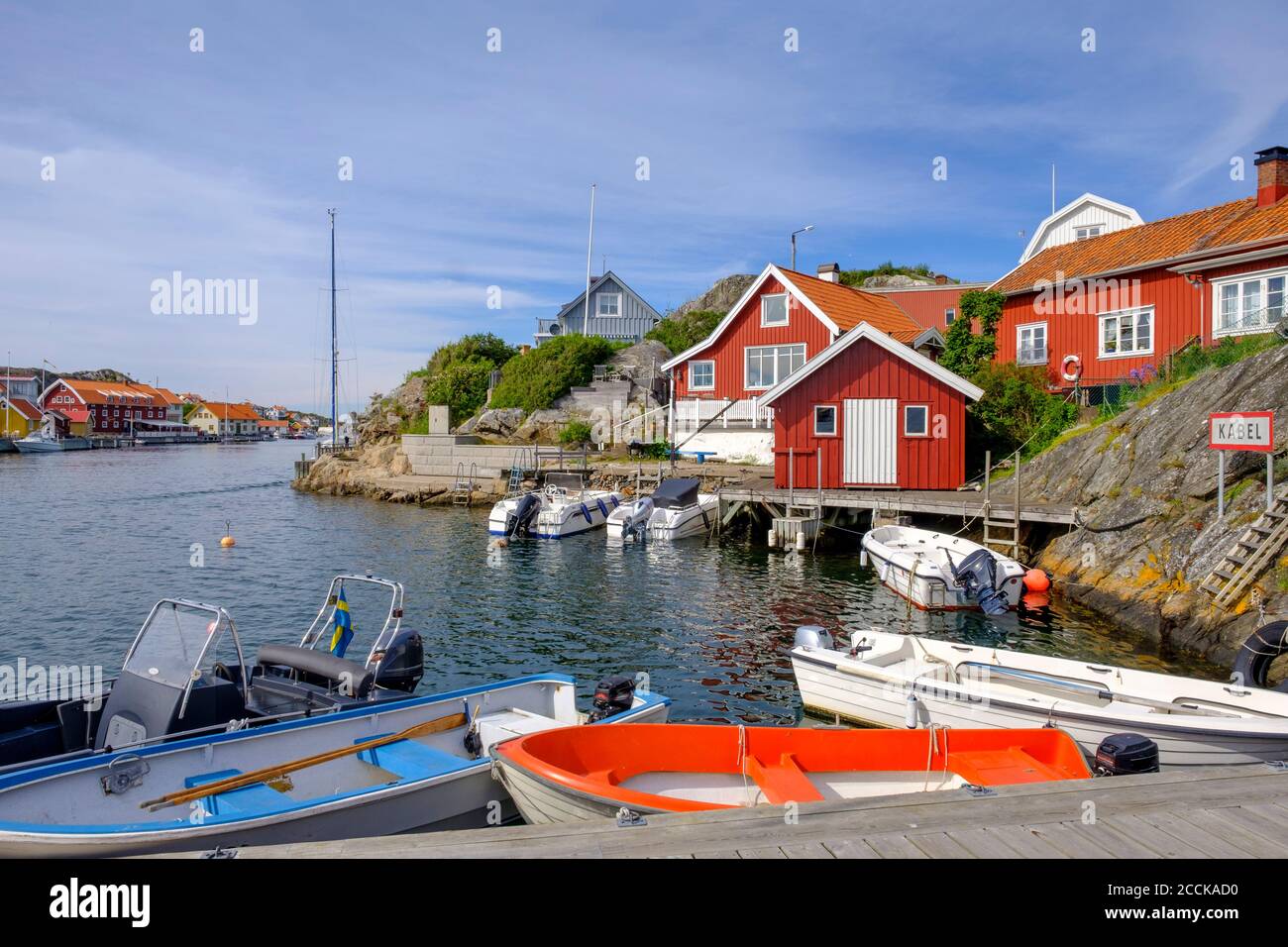 Sweden, Vastra Gotaland County, Kyrkesund, Motorboats moored in fishing village Stock Photo