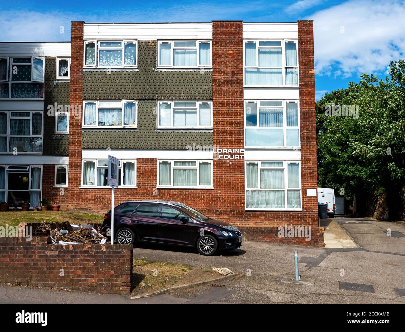 A block of apartments three stories high called Loraine Court with a for sale sign outside, taken at Red Hill Chislehurst South London 5th August 2020 Stock Photo