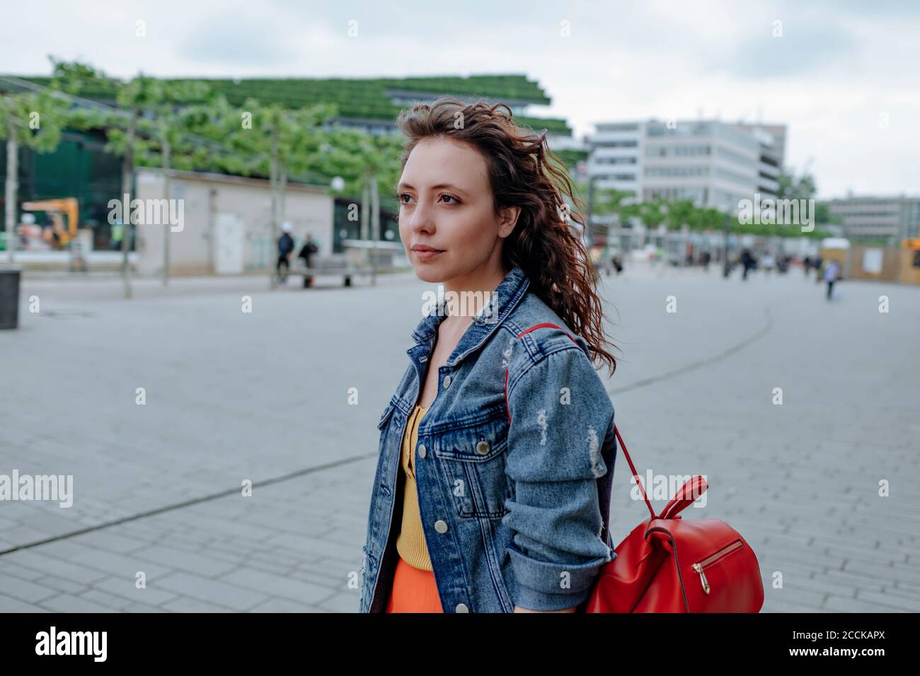 Woman walking with backpack in city hi-res stock photography and images ...