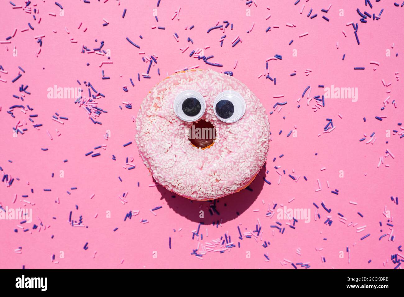 Studio shot of sweet doughnut with googly eyes Stock Photo Alamy