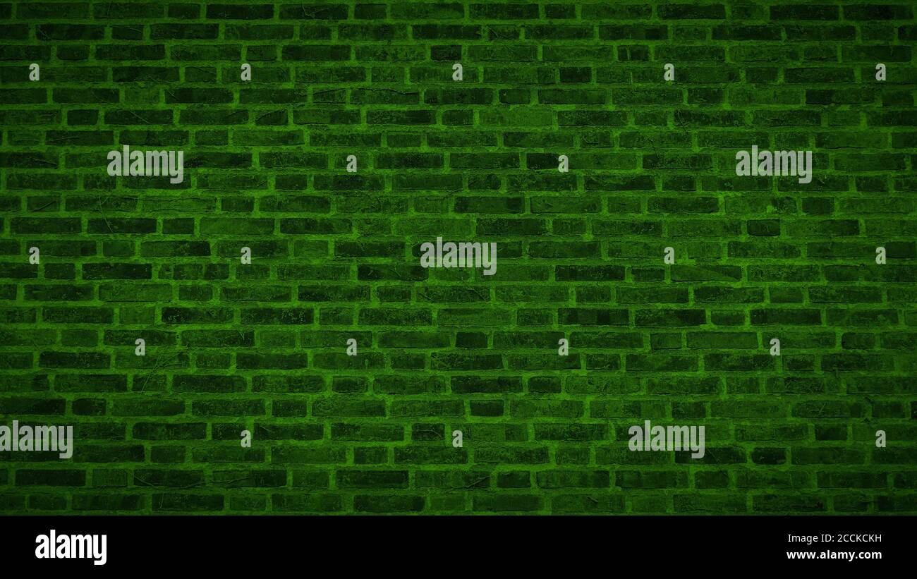 A panoramic view of an aged green brick wall texture with vignette. Stock Photo