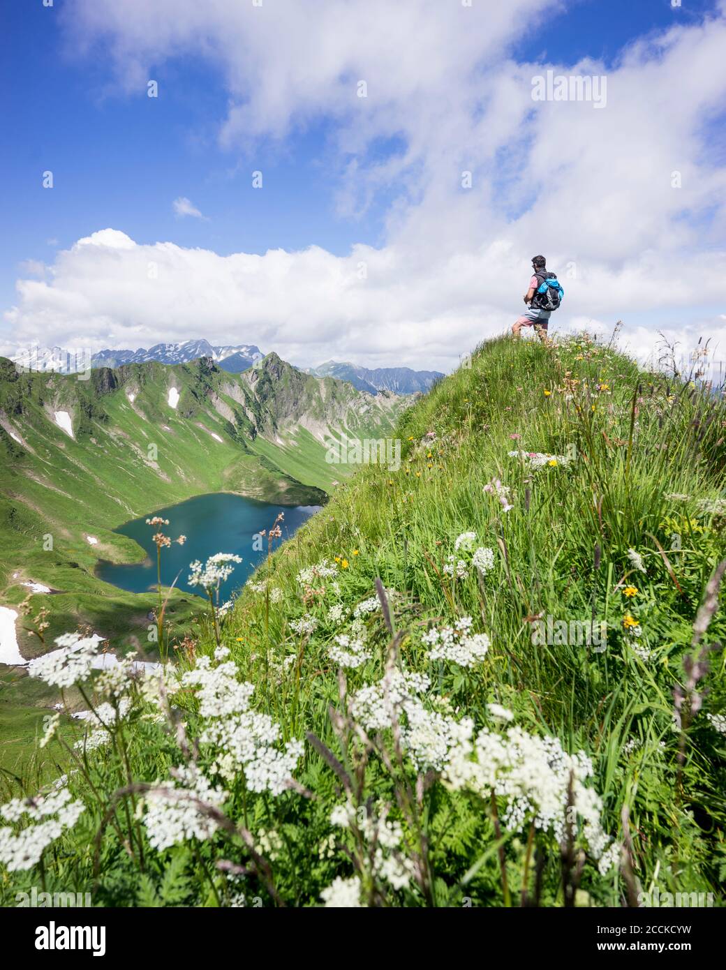 Hiker on viewpoint, Lake Schrecksee, Bavaria, Germany Stock Photo