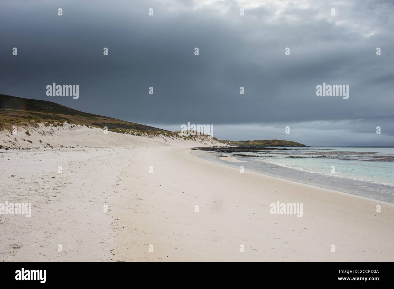 UK, Falkland Islands, Cloudy sky over sandy beach of Carcass Island Stock Photo