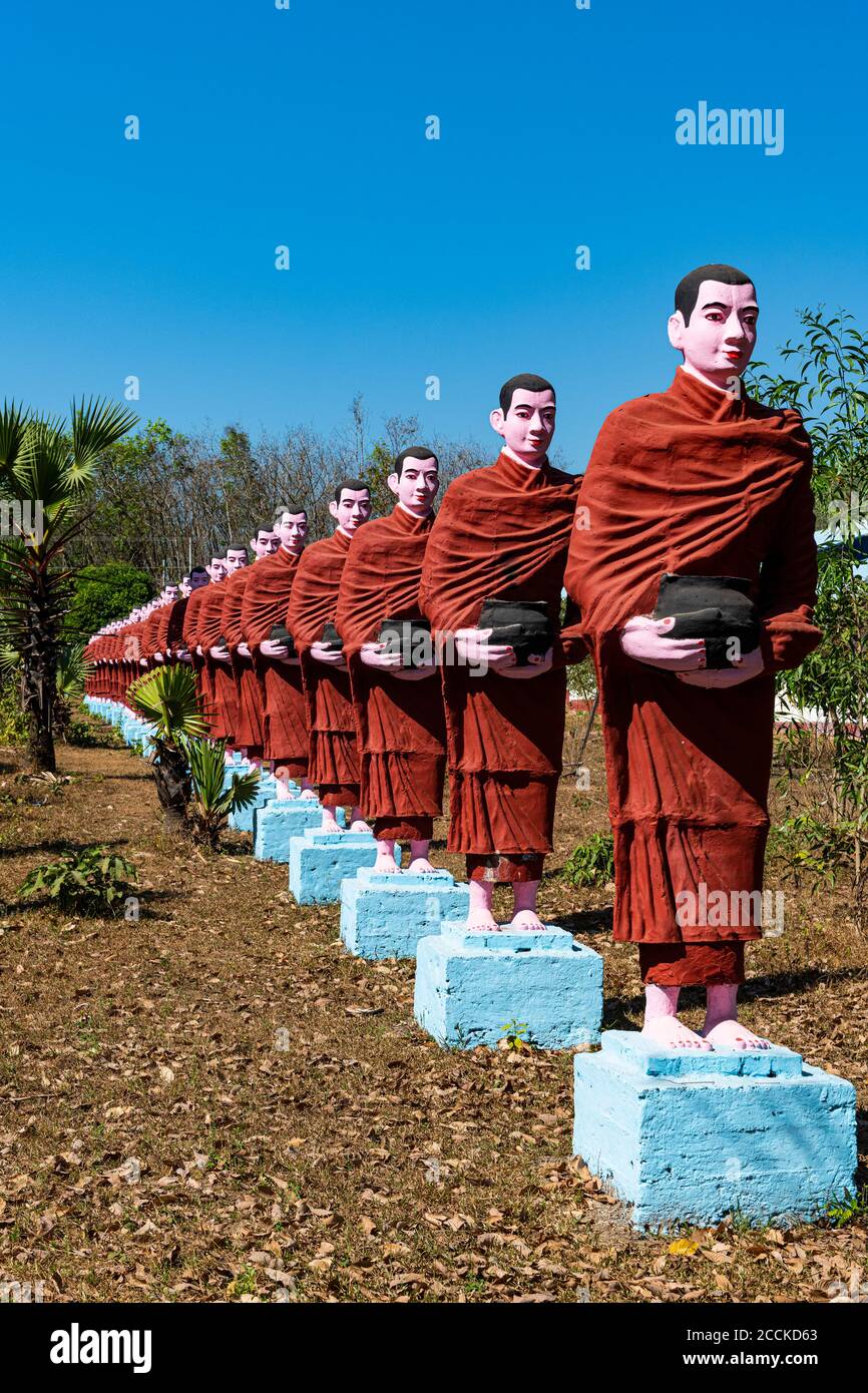 Myanmar, Mon state, outside of Mawlamyine, Row of Buddhist monks statues at Win Sein Taw Ya Stock Photo