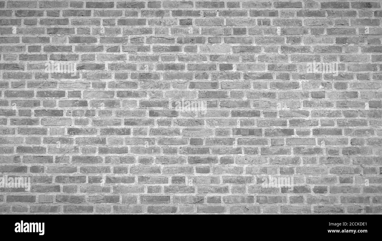 A panoramic view of an aged white brick wall texture with vignette. Stock Photo