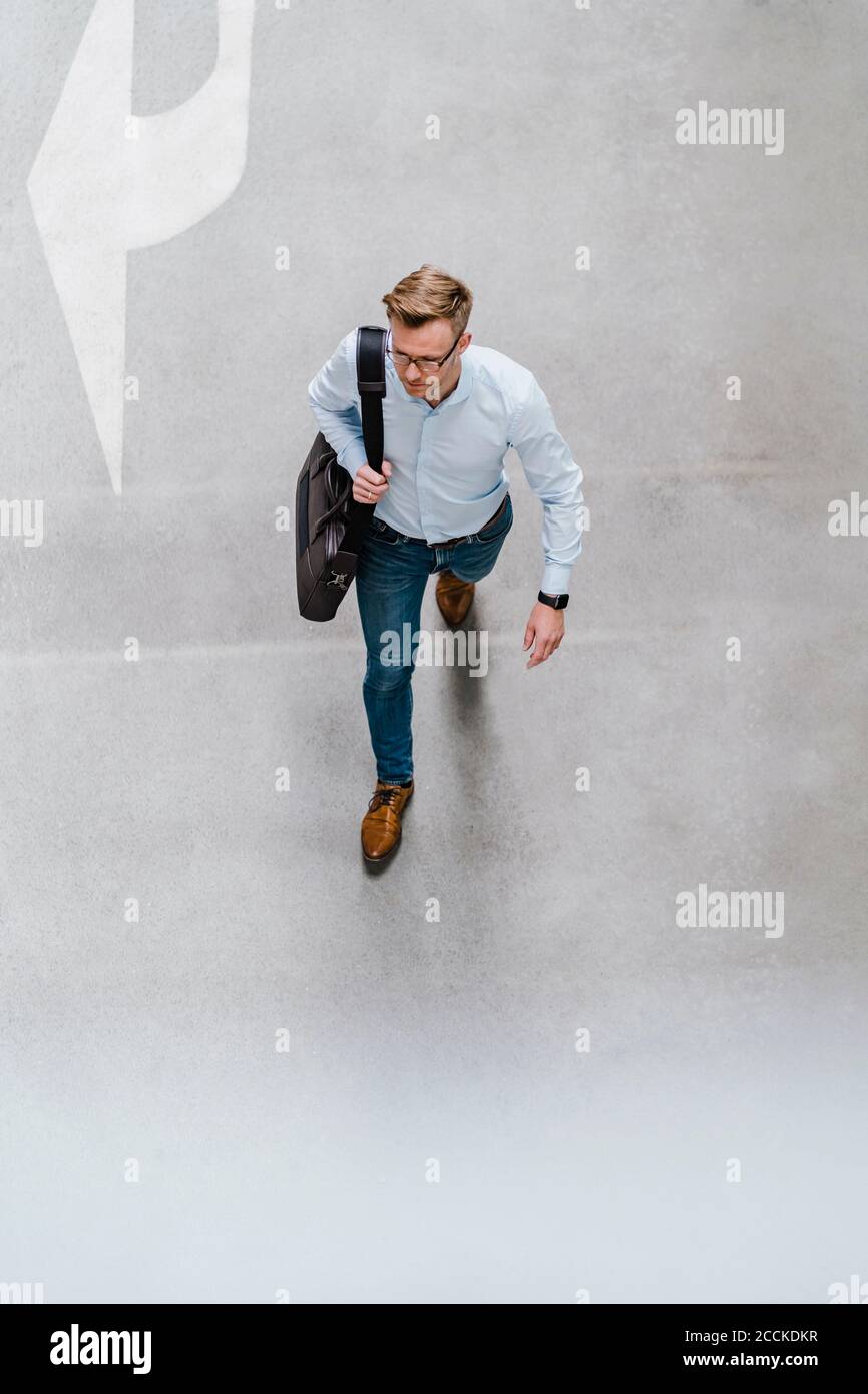 High angle view of entrepreneur with bag walking in city Stock Photo