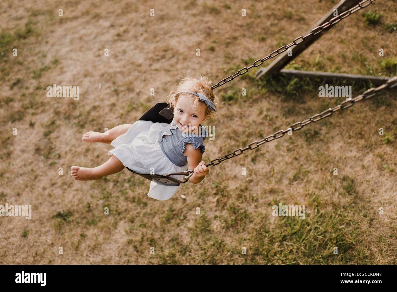 Cute little girl on  a swing Stock Photo