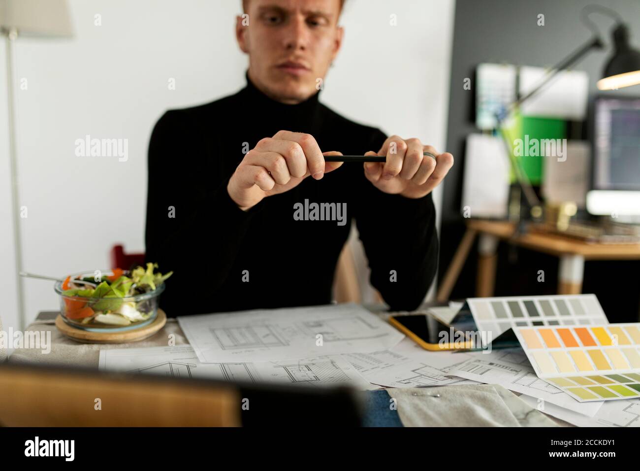 Thoughtful architect working at home office Stock Photo