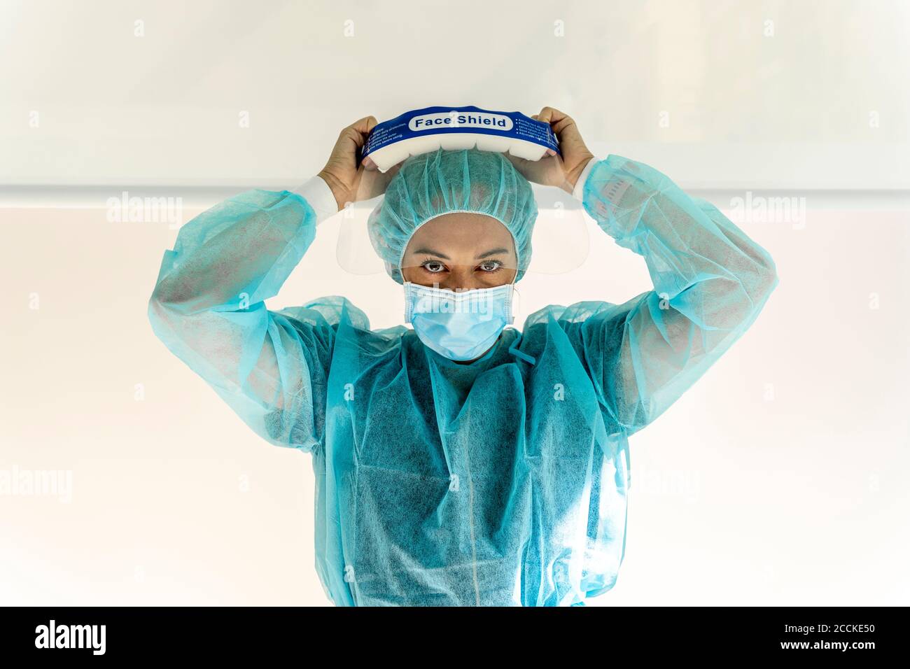 Female dentist wearing face shield in office Stock Photo Alamy