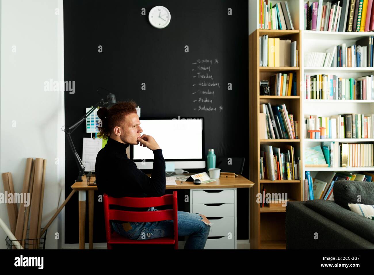 Thoughtful architect looking away while sitting at home office Stock Photo