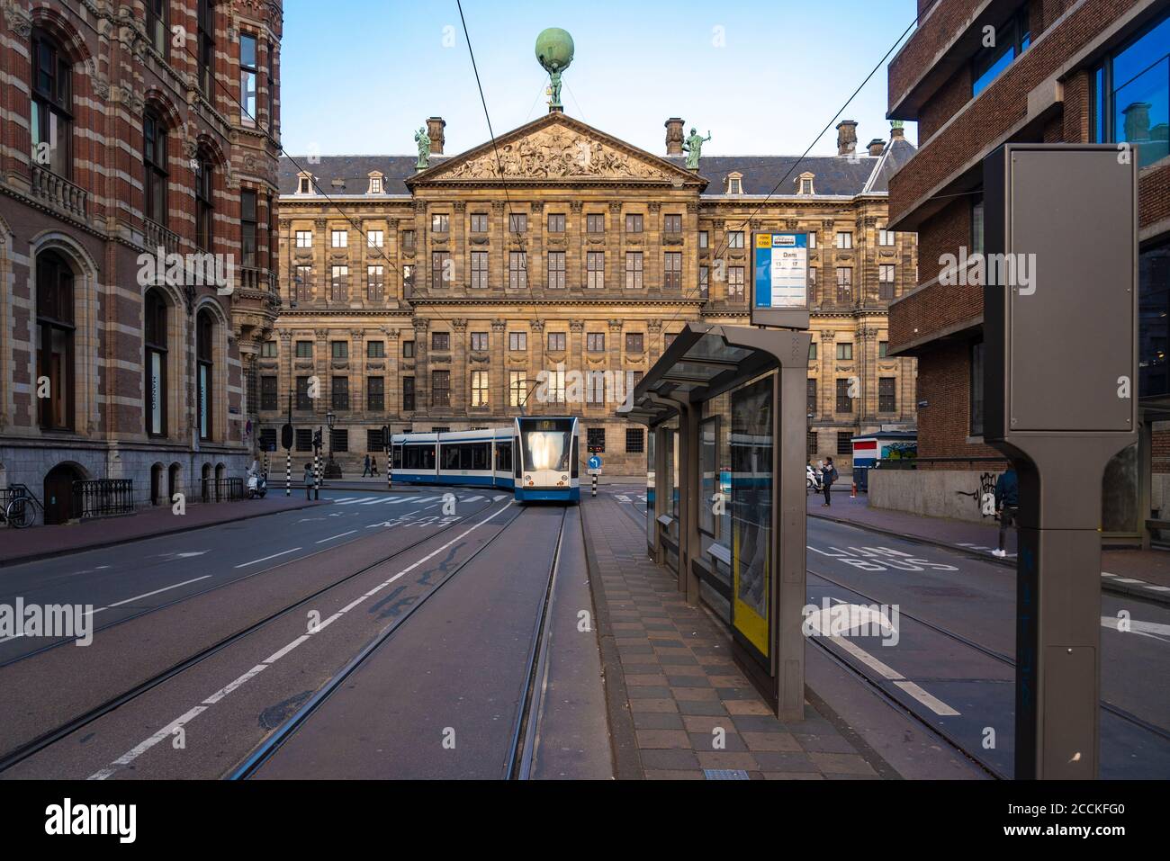 Netherlands, North Holland, Amsterdam, Train passing Royal Palace of Amsterdam Stock Photo