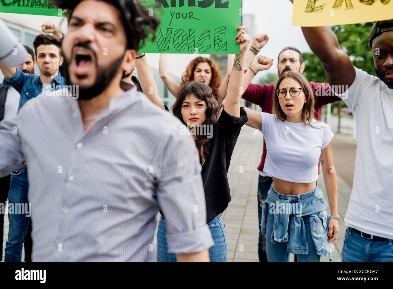 Multi ethnic people with banners protesting on street in city Stock Photo