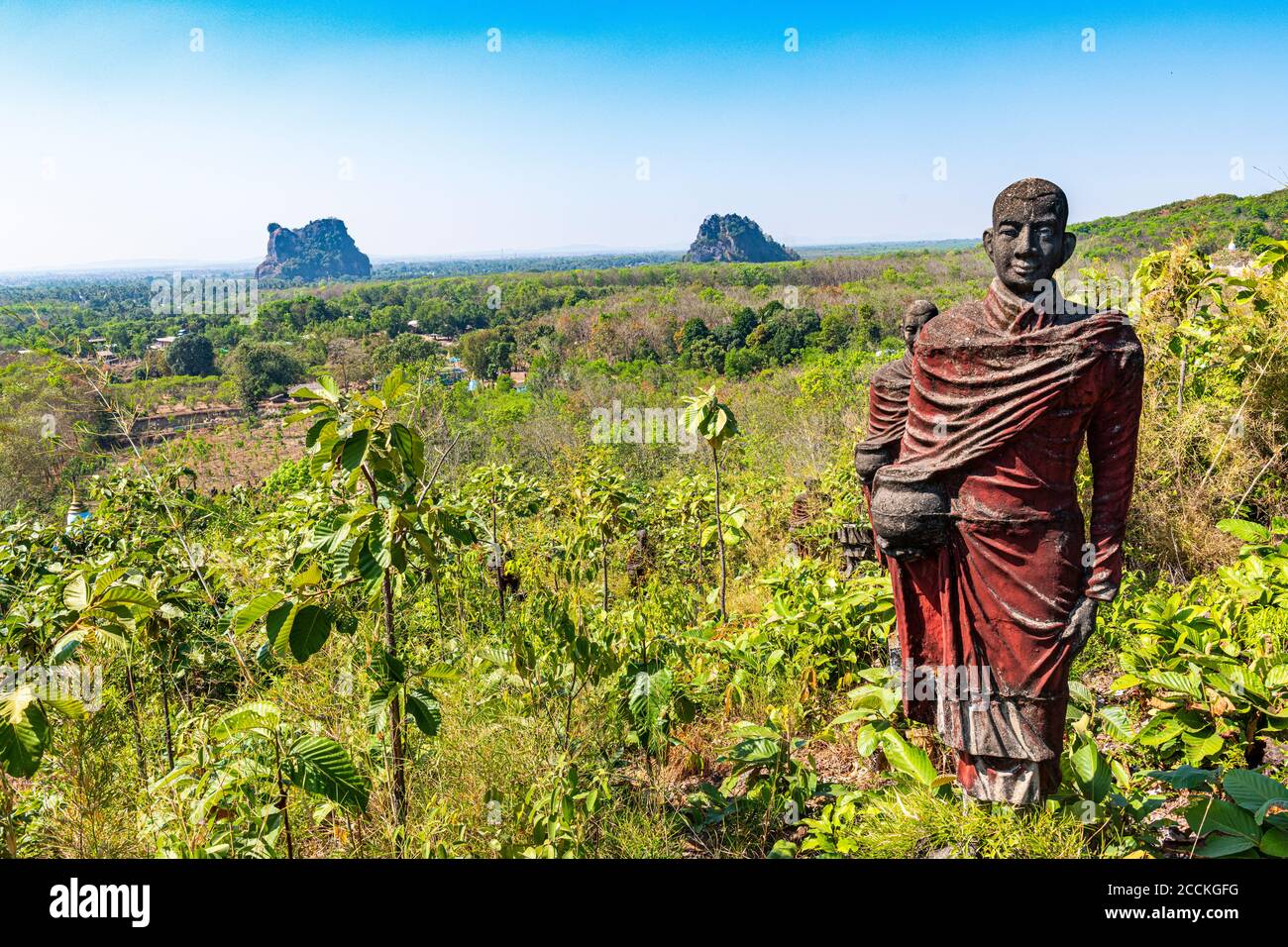 Myanmar, Mon state, outside of Mawlamyine, Buddhist monk statues in field at Win Sein Taw Ya Stock Photo