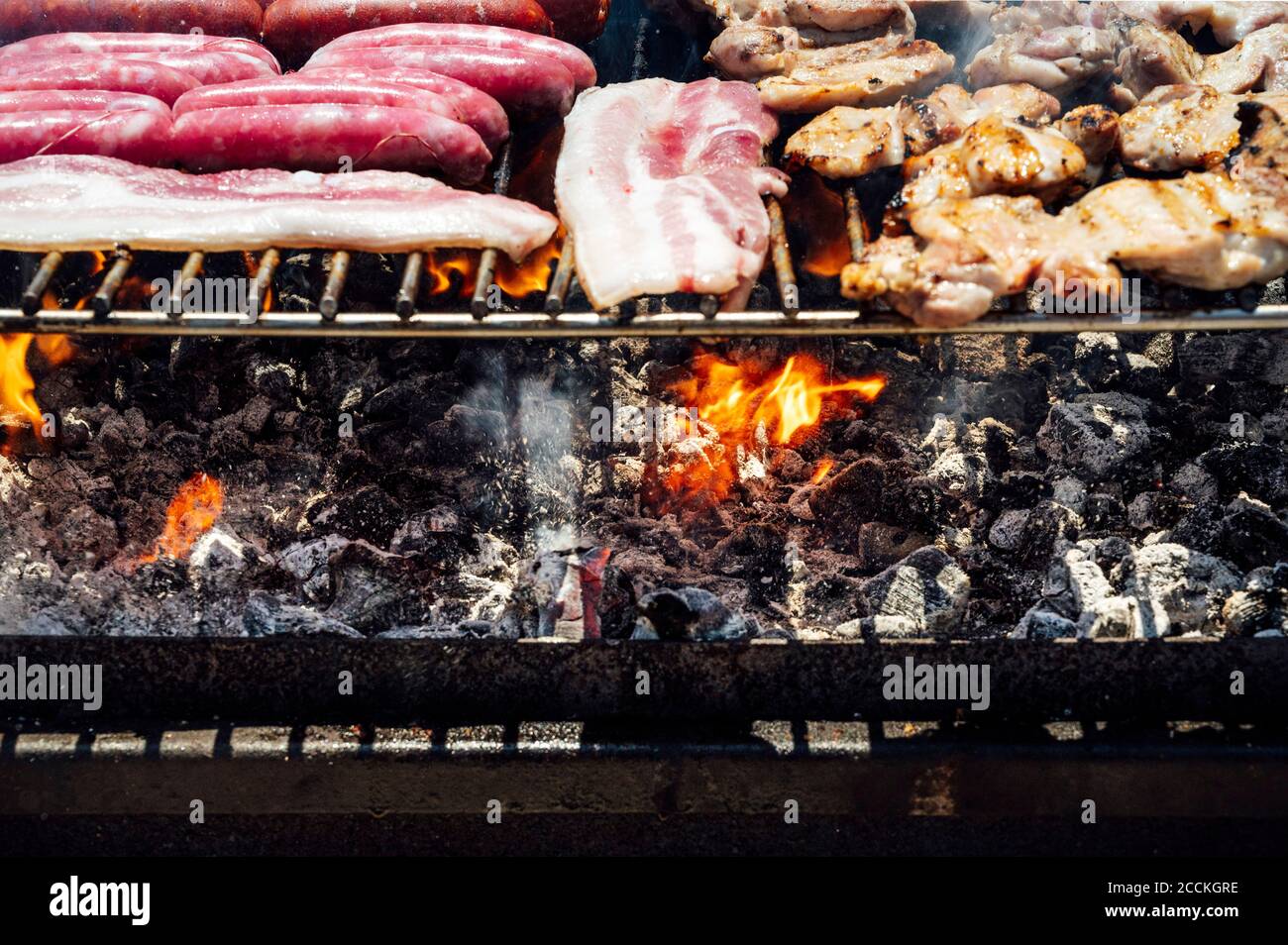 Close-up of meat and coals on barbecue grill in yard Stock Photo - Alamy