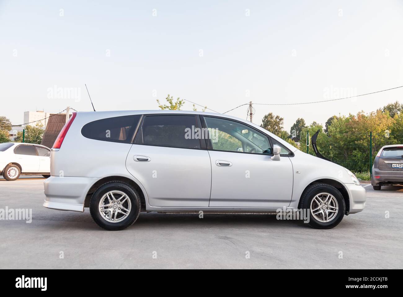 Novosibirsk, Russia - 08.05.20: Right side view of a Honda Stream car in a  silver body Japanese 2002 year van in a parking lot with a green trees and  Stock Photo - Alamy