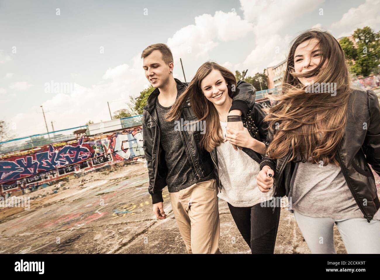 Group of friends hanging out in an old run down industrial area Stock Photo