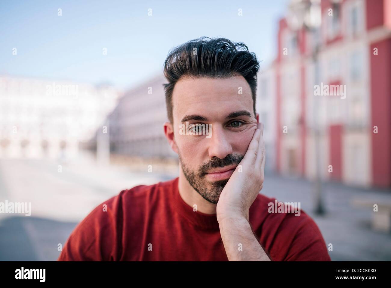 Close-up of bored man with hand on face Stock Photo