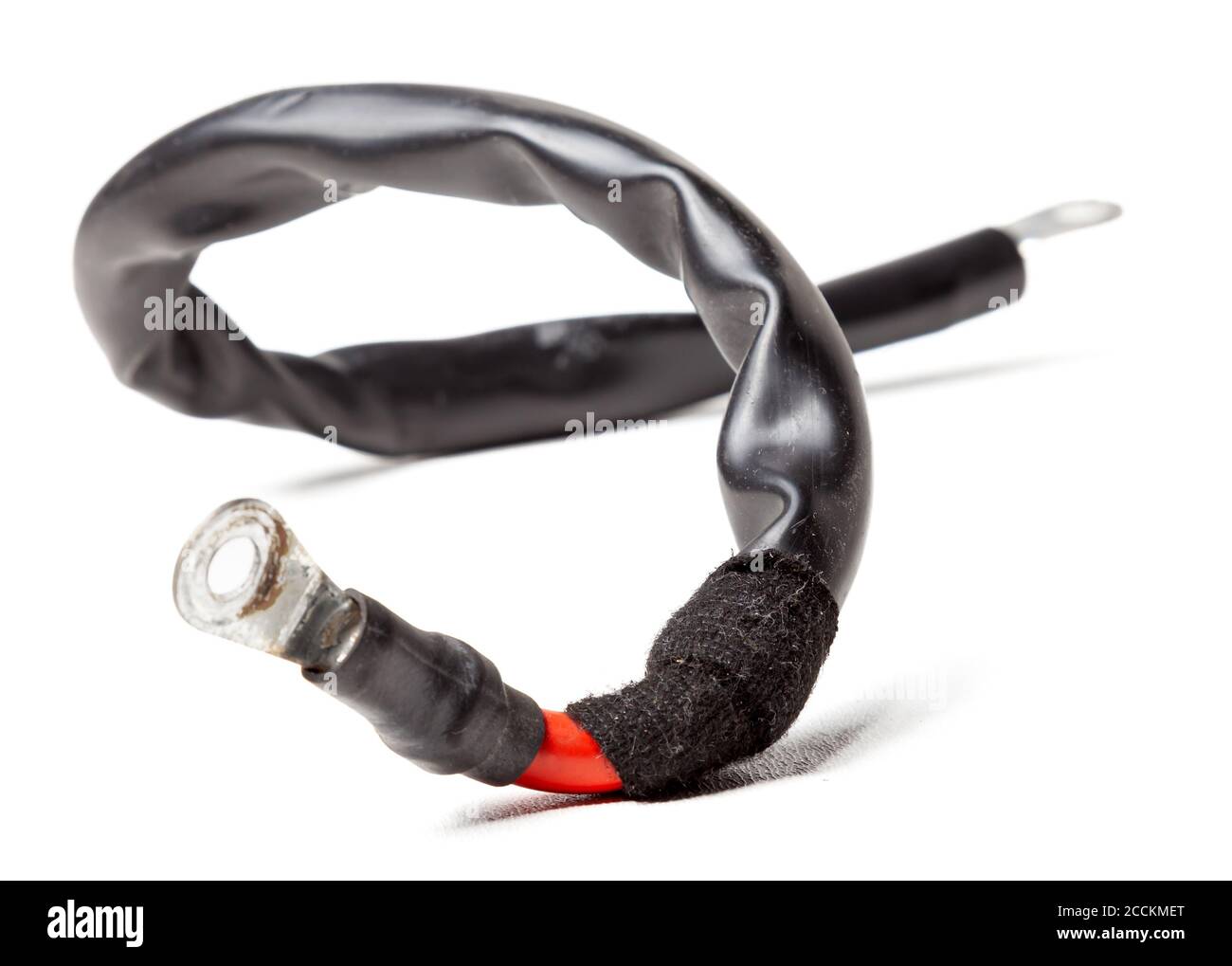 Thick short curved red electric wire in black rubber isolation on a