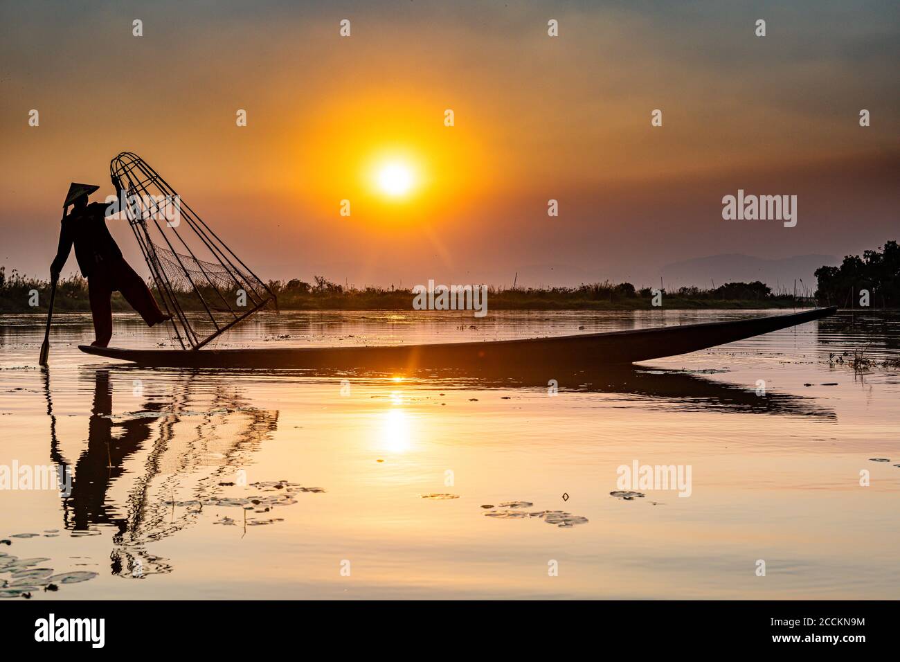 Myanmar, Shan state, Silhouette of traditional Intha fisherman on Inle lake at sunset Stock Photo