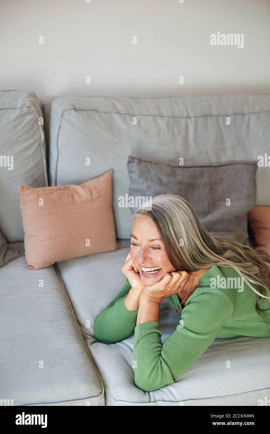 Mature woman lying on sofa hi-res stock photography and images - Alamy