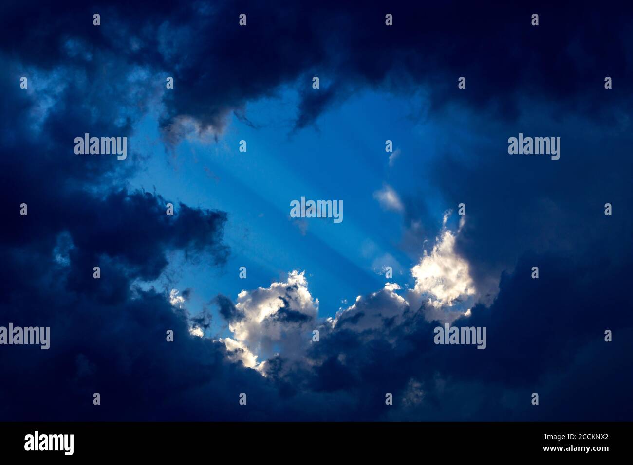 Sunbeams behind clouds Stock Photo