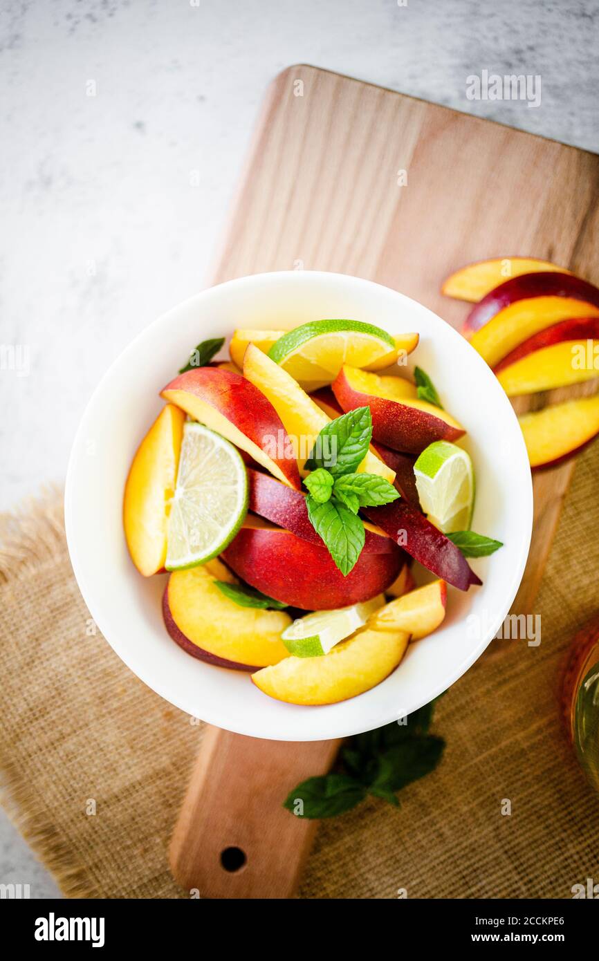 Fruit salad with peach, lime and mint Stock Photo