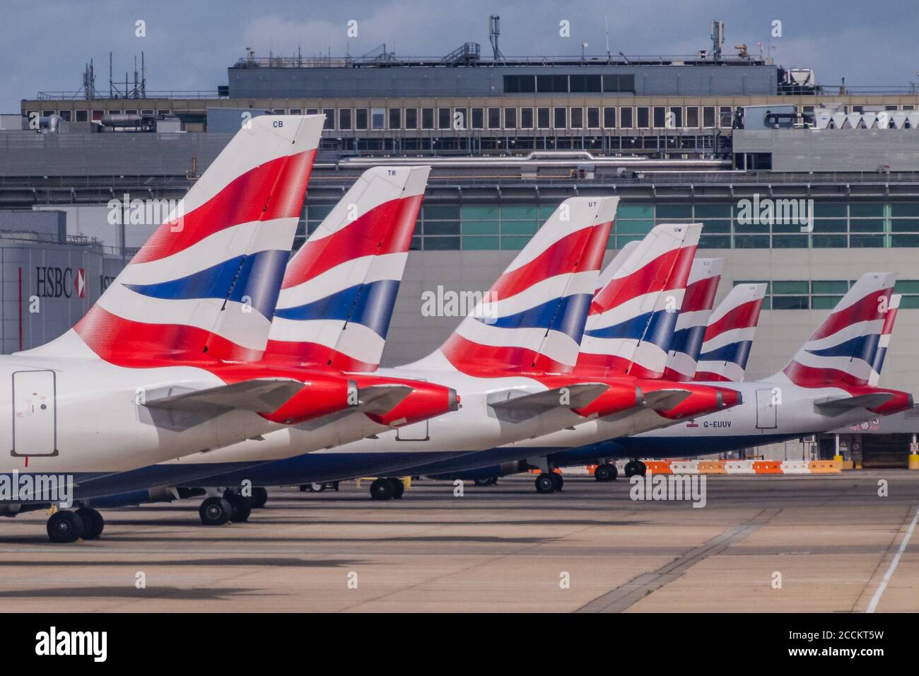 London, UK. 22nd Aug, 2020. British Airways planes docked at HSBC sponsored gates - Gatwick Airport is quiet and only the North terminal is in use - there are signs warning people to wear masks and to maintain social distancing. The 'lockdown' continues for the Coronavirus (Covid 19) outbreak in London. Credit: Guy Bell/Alamy Live News Stock Photo