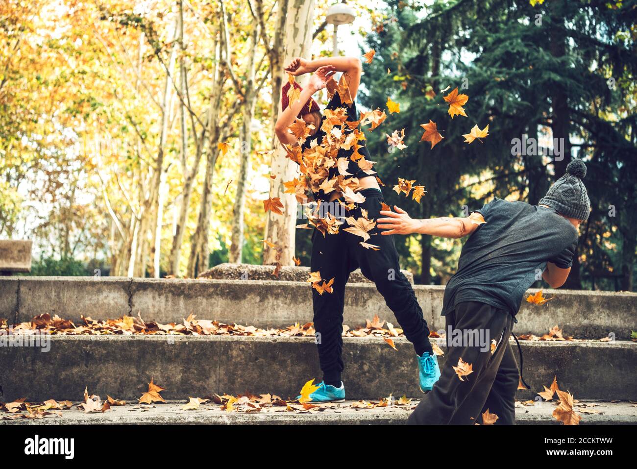 Three friends playing leaves in hi-res stock photography and images - Alamy