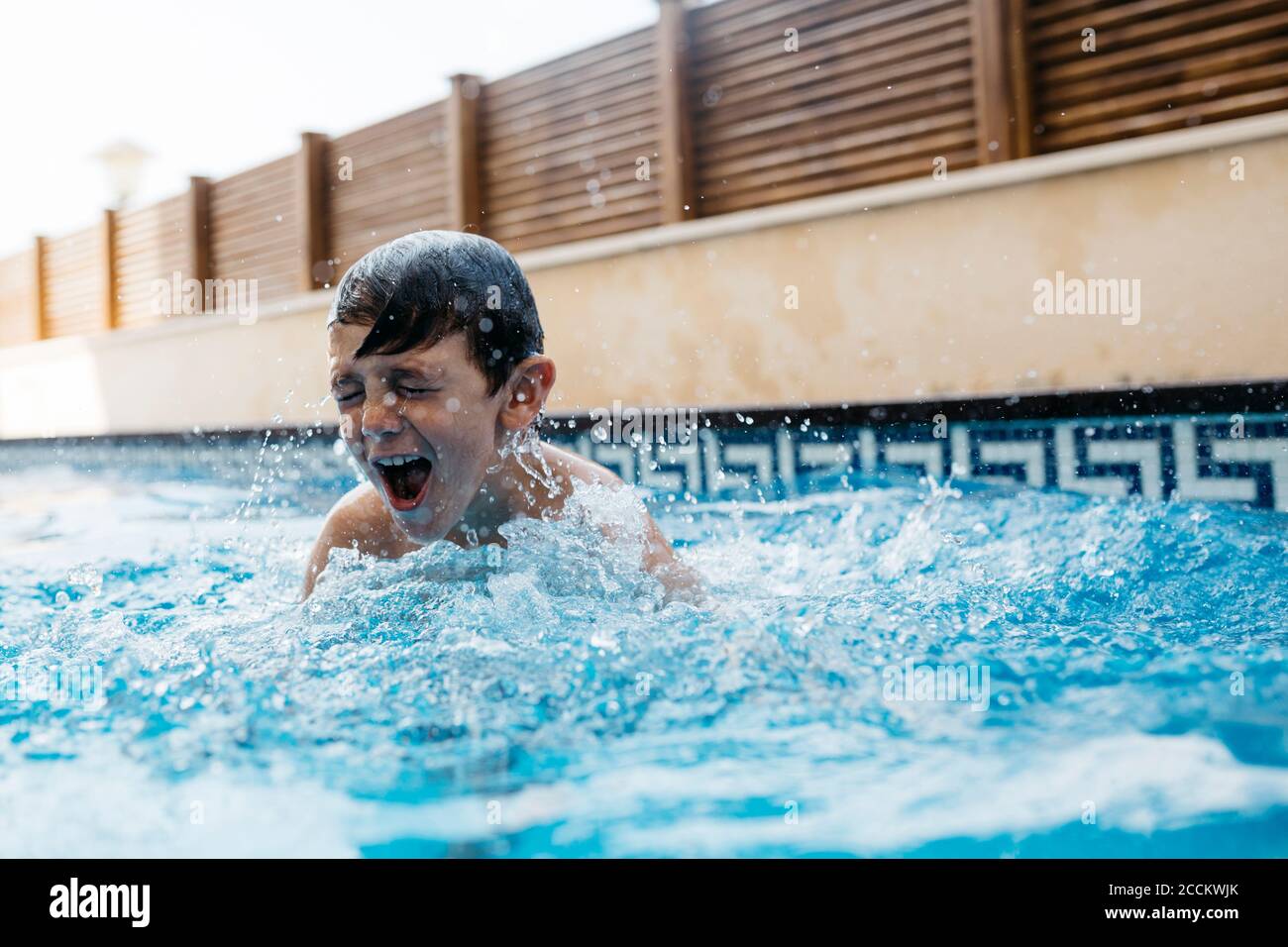 Boy playing in swimming pool hires stock photography and images Alamy