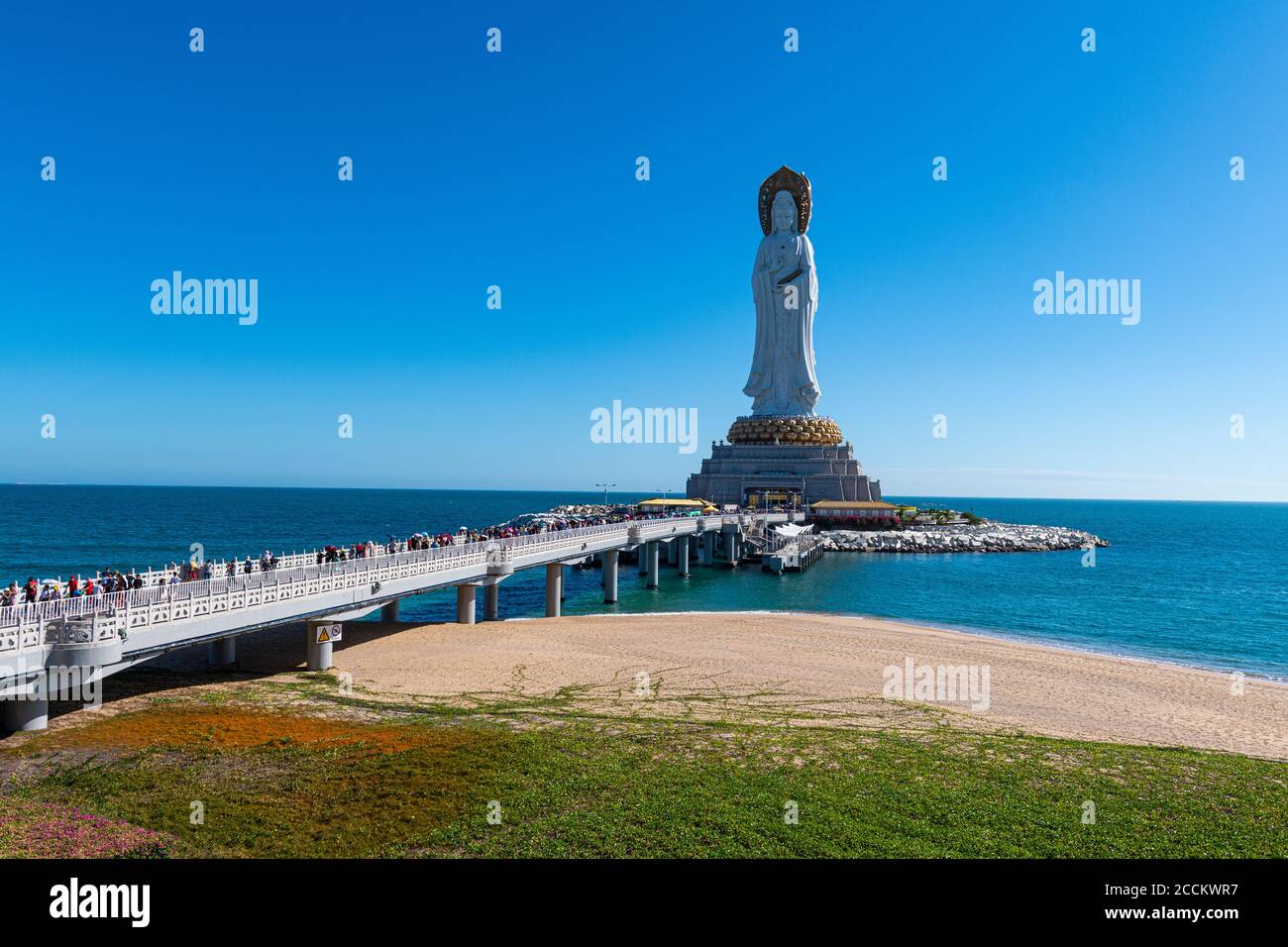 China, Hainan, Sanya, Crowded bridge leading to giant statue of Guanyin of Nanshan Stock Photo