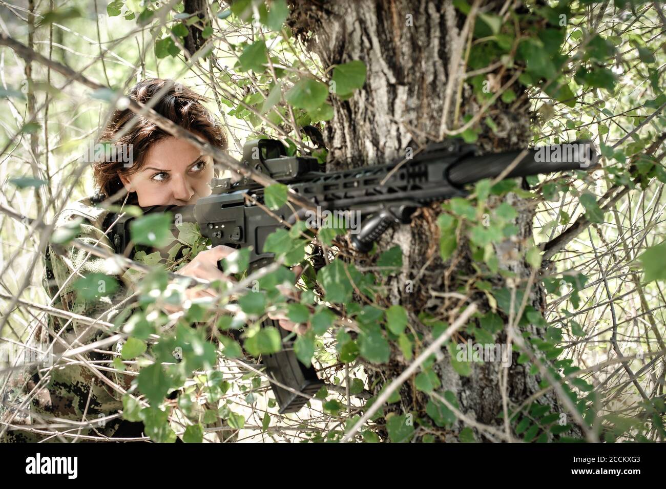 Beautiful and attractive woman soldier shooting with rifle machine gun in  the forest. Female army nature outdoor military combat training. Femme fata  Stock Photo - Alamy