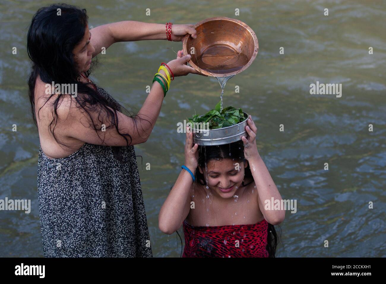 Kathmandu, Nepal. 23rd Aug, 2020. Nepalese Hindu woman takes a holy bath in the Bagmati river during the Rishi Panchami festival.Rishi Panchami is observed on the last day of Teej when women worship Sapta Rishi (Seven Saints) to ask for forgiveness for sins committed during their menstrual period throughout the year. The Hindu religion considers menstruation as a representation of impurity and women are prohibited from taking part in religious practices during their monthly menstruation. Credit: SOPA Images Limited/Alamy Live News Stock Photo