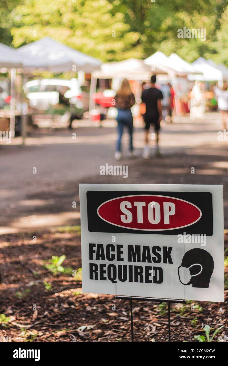 A sign in front of the farmers' market at UNCA says "STOP, FACE MASK REQUIRED" in Asheville, NC, USA Stock Photo