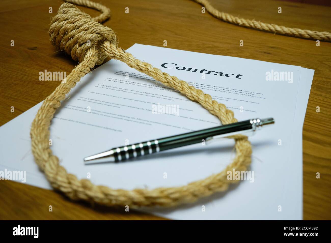 Contract with pen and rope tied in hangmans noose. Strangulation contract, unfair agreement. Lorum Ipsum text Stock Photo
